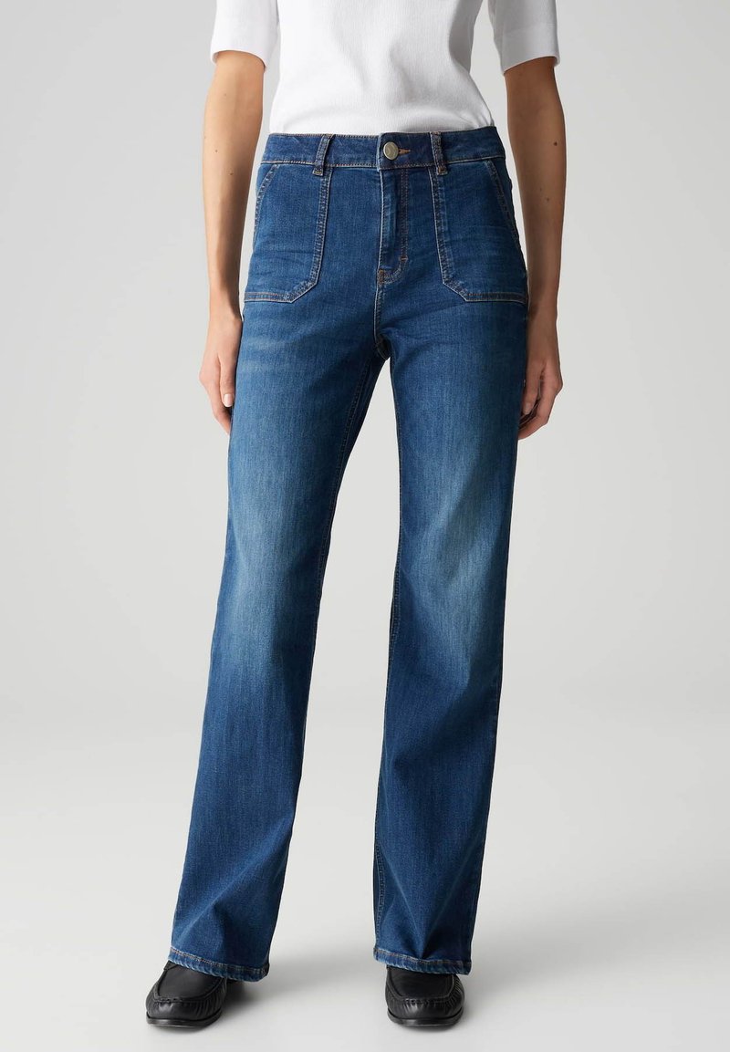 Jeans in denim blu scuro con design a gamba dritta, dotati di cinque tasche, vita alta e chiusura con bottone. Leggera scoloritura sulle gambe.