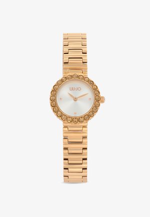 Orologio color oro con quadrante rotondo, bezel decorato con cristalli e bracciale in metallo lucido. Presenta un quadrante bianco con accenti in oro rosa.