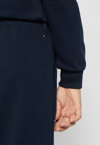 Jūras spēku sporta džemperis ar ribotu piedurkņu un apakšmala. Iezīmēts ar mazu zīmola logo sarkanā, baltā un zilā krāsā. Mīksts, teksturēts audums.