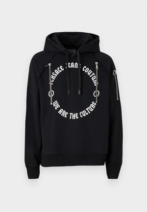 Black cropped hoodie with a spacious hood, featuring a circular white graphic print and two metal zippered pockets on the front.