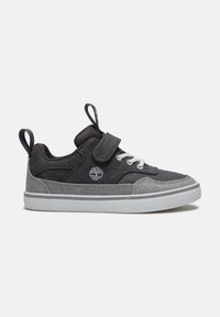 Low-top black and gray sneaker with white laces, a velcro strap, pull tabs on tongue and heel, and a white rubber sole.