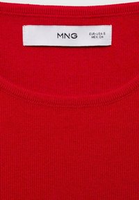 Red knitted sweater with a ribbed texture. Features a crew neckline. Label shows brand "MNG" and size "EUR- S."