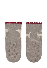 Braune Socken mit wellenförmigem maroonem Rand, versehen mit beigen Tiermustern und strukturierten Grip-Dots an den Sohlen für besseren Halt.