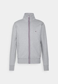 Sudadera gris con cremallera y cuello alto, presenta rayas verticales en rojo, blanco y azul marino. Incluye bolsillos laterales y puños acanalados.