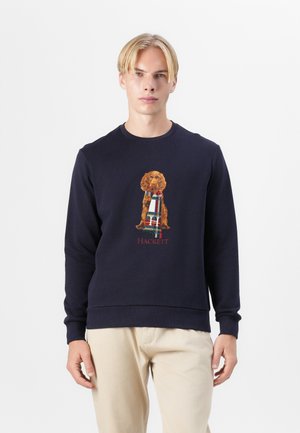 Sudadera navy de algodón, con un diseño bordado de un perro que lleva una bufanda de estampado y el texto "HACKETT" en rojo en la parte inferior.