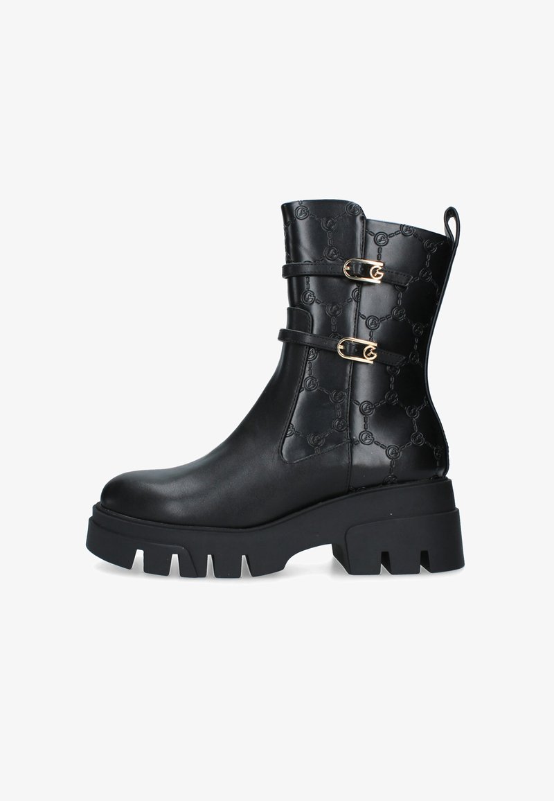 Stivali ankle in pelle nera con suola platform, motivo a logo embossato, dettagli con doppia fibbia e punta arrotondata. Finitura texturizzata sui lati.
