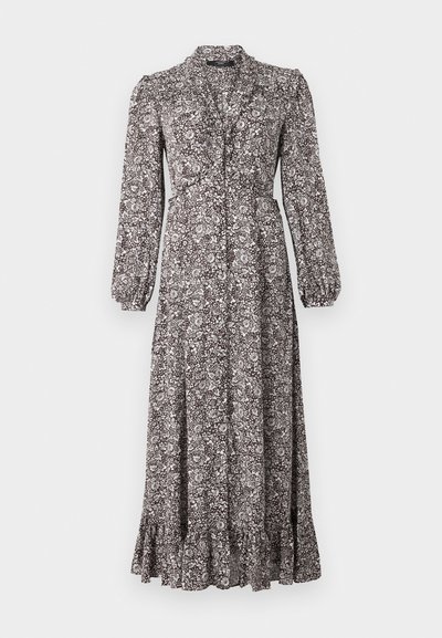 Long, button-down dress made of patterned fabric in shades of brown and white, featuring long sleeves and a ruffled hem.