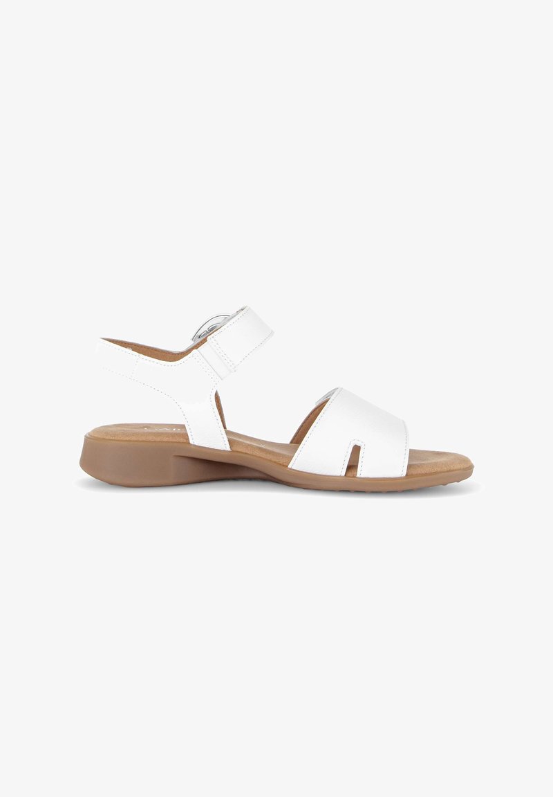Sandale ouverte en cuir blanc avec bride cheville réglable, semelle intérieure rembourrée couleur tan et semelle extérieure en caoutchouc marron basse, idéale pour un usage décontracté.