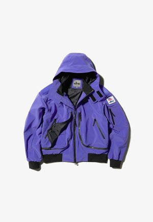 Purple, waterproof jacket with a hood, multiple zippered pockets, black accents, and a logo patch. Smooth texture with a relaxed fit.