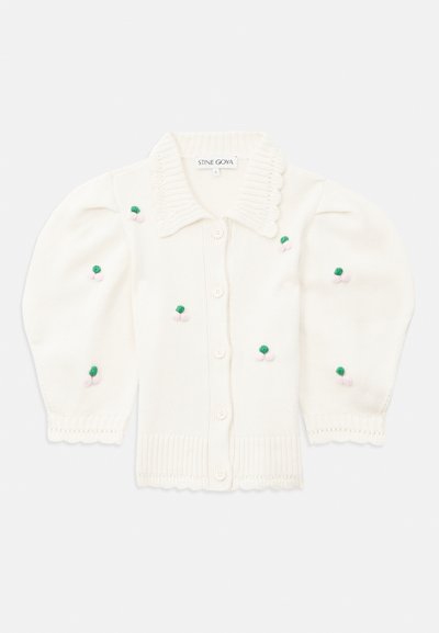 Biela pletená kardigán s vlnitým golierom, gombíkmi a balónovými rukávmi. Obsahuje vyšívané kvety v zelených a ružových odtieňoch.