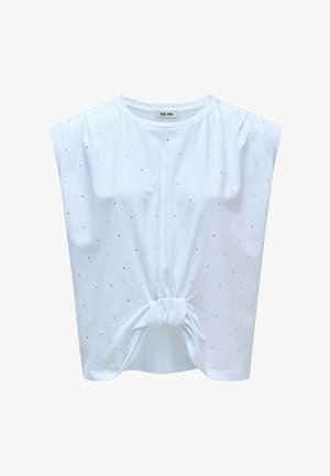 Haut blanc à manches courtes avec un design noué à l'avant, orné de petits points argentés pour la texture et le détail. Fabriqué en tissu doux.