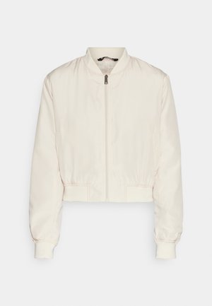 Cropped bomber jacket in light cream, featuring a round neckline, front zipper, and elastic cuffs and hem. Smooth, glossy texture.