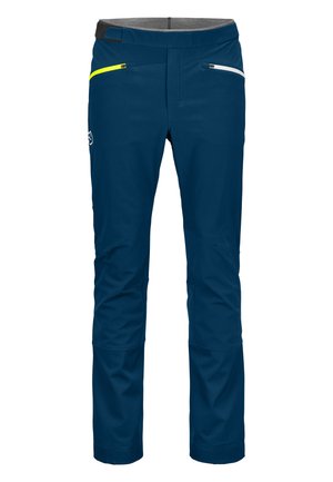 Navy blue pants with a smooth texture, featuring two front zip pockets (one with yellow accents), and a comfortable waistband.
