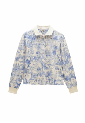 Long-sleeve cream-colored polo shirt with blue scenic cityscape and palm tree print, featuring a white collar and cream cuffs.