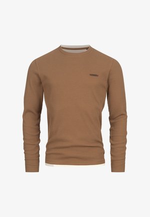 Brown lange mouwen shirt gemaakt van ribbelstof. Heeft een ronde hals en een klein accentdetail op de linkerborst.