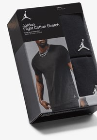 Black crew neck undershirts in a two-pack, made from cotton stretch material, featuring a white Jordan logo on each shirt.