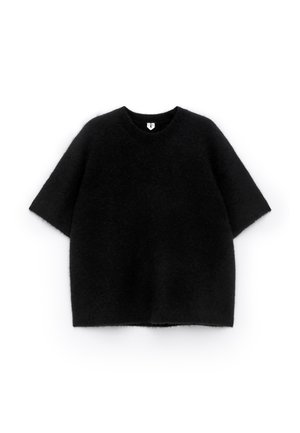 Black, short-sleeved sweater made of soft, fuzzy material with a round neckline. Features a loose, boxy fit and minimal detailing.