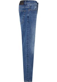 Jean en denim bleu skinny avec un lavage moyen, cinq poches, des effets de décoloration sur le devant et une étiquette en cuir à l'arrière de la taille.