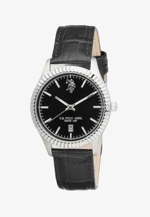 Montre U.S. Polo Assn. à cadran noir avec index argentés, affichage de la date à 6 heures, lunette argentée texturée et bracelet en cuir noir.