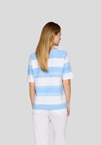 Short-sleeve, color-blocked top featuring horizontal blue and white stripes, made from soft fabric, with a relaxed fit and round neckline.