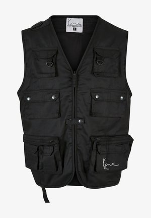 Schwarze Utility-Weste mit mehreren Fronttaschen, Reißverschlüssen und Druckknöpfen. Hergestellt aus strapazierfähigem Stoff mit glatter Textur und verstellbaren Trägern.