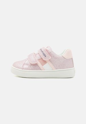 Pink glittery toddler sneaker with two velcro straps, white sole, and light pink and white accents.