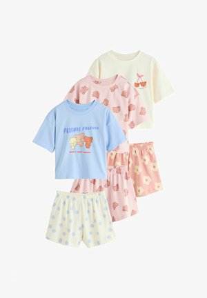 Three sets of children’s pajamas: blue top with teddy bears and "Friends Forever," pink top and shorts with bear prints, cream top and polka dot shorts.