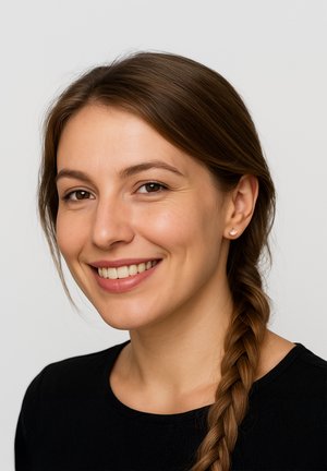 Ritratto di una persona con lunghi capelli castani raccolti in una treccia, che indossa una maglietta nera. Le caratteristiche includono una carnagione chiara e orecchini semplici.