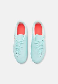 Light blue athletic shoes with a smooth texture, black logo, white accents, and pink insoles. Features traditional shoelace design.