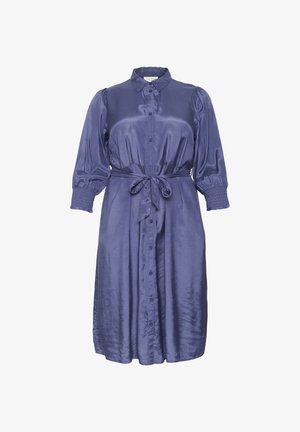 Mygtukų suknelė iš ryškaus purpurinio satino, turinti pūkuotas rankoves, diržą juosmenyje ir surenkamus rankogalius, sukuriantis struktūrišką siluetą.