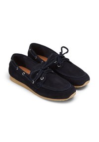 Marineblaue Wildleder Slipper mit Schnürsenkeln, weißen Nähten und silbernen Ösen. Sie verfügen über eine flache Gummisohle in einem leicht bräunlichen Farbton.