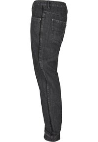 Pantalon en denim noir avec une coupe slim, doté d'un design à jambe droite, de deux poches arrière et de poignets côtelés aux chevilles.