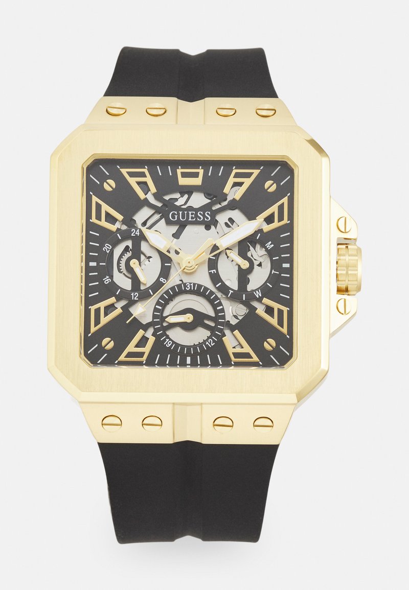 Gold rectangular watch with black rubber strap. Features a black and gold dial, three subdials, and bold hour markers.