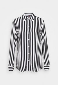 Camicia a maniche lunghe a righe bianche e nere con chiusura a bottoni e polsini a righe contrastanti. Realizzata in tessuto leggero.