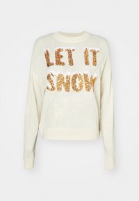 Ljus gräddfärgad kortärmad tröja med texten "LET IT SNOW" i guldfärgade paljetter, rund halsringning och ribbade ärmslut. Texten har en strukturerad yta.