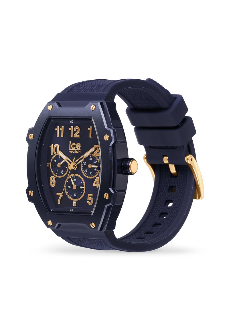 Montre octogonale noire avec accents dorés, bracelet en caoutchouc noir texturé, grands marqueurs d'heure et trois sous-cadrans pour la fonctionnalité chronographe.
