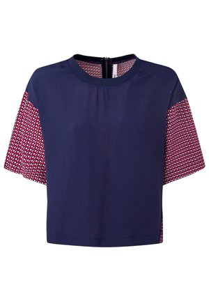 Navy crop top with short patterned sleeves featuring red and white geometric designs, round neckline, and a back zipper.