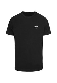 Zwarte katoenen t-shirt met een klein wit "TOXIC BEAST" logo met een atoomsymbool op de linkerborst, korte mouwen, klassieke pasvorm.