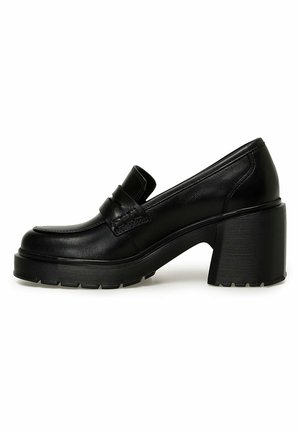 Black leather loafer with chunky block heel and thick ridged sole, featuring a strap detail across the upper.