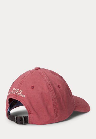 Red Polo Ralph Lauren baseball cap with adjustable leather strap and embroidered logo on the back, shown from a rear side angle.