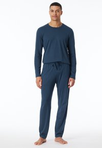Langärmliges Schlafanzugset in Marineblau aus weichem Stoff; mit rundem Ausschnitt und elastischem Bund mit Kordelzug an der Hose.