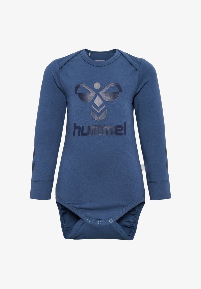 Granatowy kombinezon z długim rękawem z dużym nadrukiem logo oraz ciemnymi akcentami na rękawach. Wykonany z miękkiej tkaniny, z zapięciem na napy na dole.