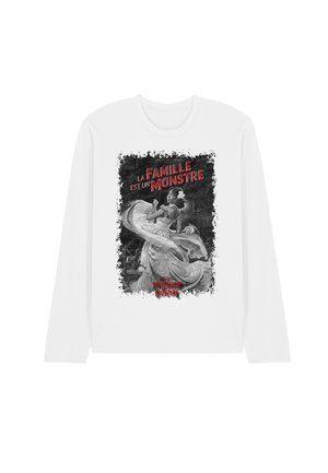 White long-sleeve shirt with black-and-white dancing woman illustration and red text "La Famille est un Monstre" and "Interview Vampire" at the bottom.