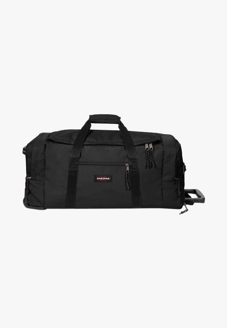 Sac de sport noir en tissu durable, avec deux poignées supérieures, des compartiments zippés et une poignée rétractable pour un transport facile.