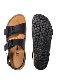 Sandalias negras con dos correas ajustables, una plantilla de corcho y una suela de goma texturizada con un patrón en forma de ola.