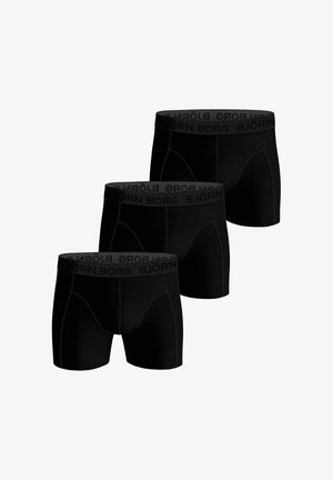 Kolmet mustat bokserit, joissa on merkkilogolla varustetut joustavat vyötäröt, joissa lukee "BJÖRN BORG" tummanharmaalla tekstillä.