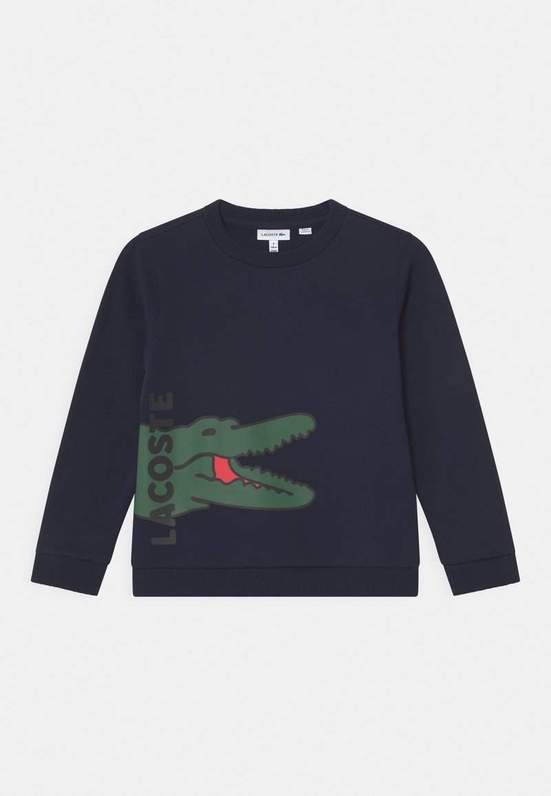 Navy sweatshirt med rundad halsringning, ribbade muddarn och fåll. Har en stor grön krokodil-logotyp med röda detaljer på framsidan.