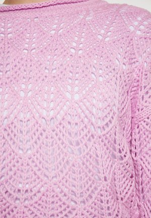 Lys rosa strikket sweater med et åbent lace mønster med diamantformer og ribbet halsudskæring. Blød tekstur, let design.