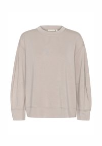 Sweat-shirt beige clair à manches longues avec col rond, épaules tombantes et coutures visibles sur les manches, les poignets et l'ourlet.