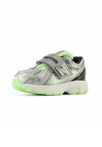 Gray synthetic sneaker with green accents, mesh upper, two velcro straps, and textured sole for traction. Rounded toe and cushioned collar.